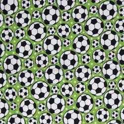 Fodbolde på bred grøn bomuldsstof sorte og hvide