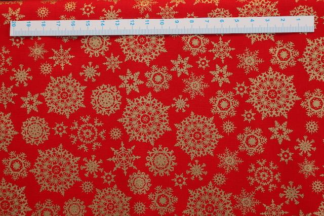 Klar rød julepatchworkstof med guld iskrystaller