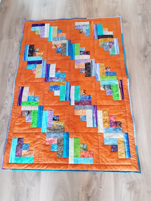 Hej Hanne  Hermed fotos af det første af mine 2 tæpper.  Jeg kunne ikke få de forskellige bundfarver sat sammen i ét tæppe, så det ender med to tæpper på 4 × 6 blokke.   Mvh Lene