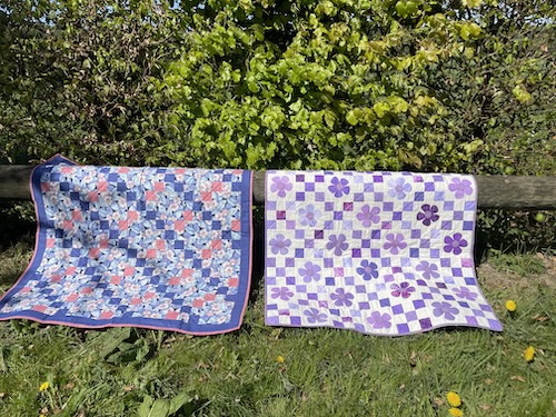 Blomster og firkanter giver smukt Østermarie baby tæppe