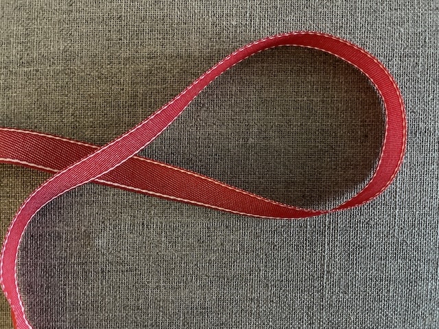 Rød pyntebånd med hvid kant. 15 mm bred. Pris pr meter